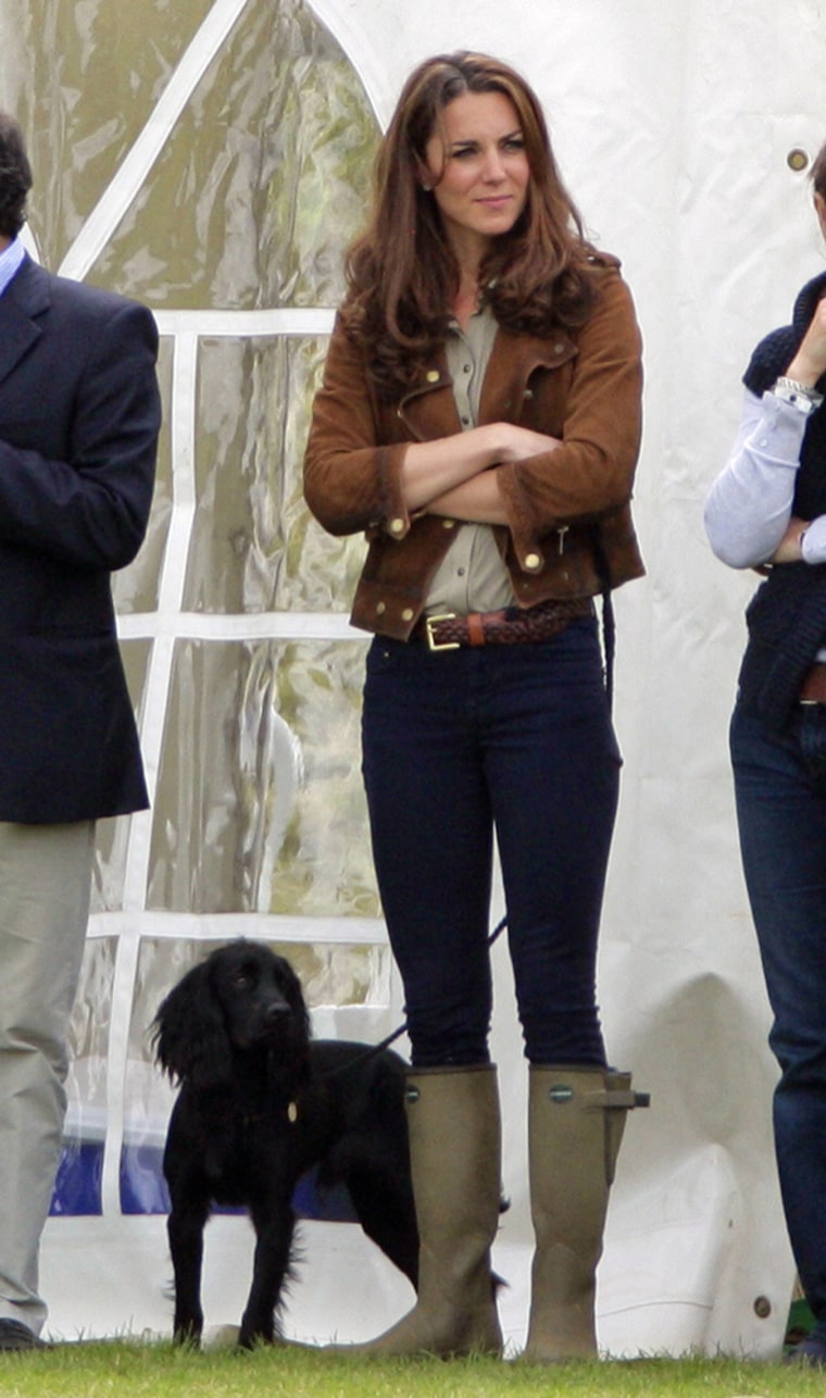 Puppy love: Kate, with her pup, Lupo, attends The Golden Metropolitan Polo Club Charity Cup polo match, in which Prince William and Prince Harry played, at the Beaufort Polo Club on June 17.