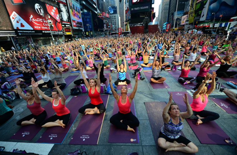 Yoga practitioners gather in Times Square Stock Photo - Alamy