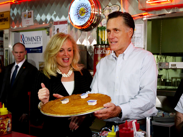 Pass the syrup! Republican presidential candidate Mitt Romney and his wife, Ann, deliver a pancake during a campaign stop at Charlie Parker's Diner in Springfield, Ill., on March 19.
