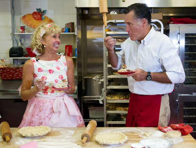 Linda Hundt, left, owner of Sweetie-licious Bakery, laughs as Republican presidential candidate Mitt Romney takes a bite of cherry pie during a campaign stop in DeWitt, Mich., on June 19.