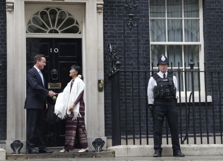 Britain's Prime Minister David Cameron greets Chairperson and General Secretary of the National League for Democracy Aung San Suu Kyi in Downing Street in London on June 21, 2012. Nobel laureate Suu Kyi continued an emotional visit to Britain where she left her family 24 years ago and took up her famous struggle against the military dictatorship in her homeland.