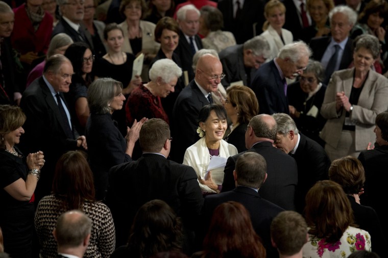 Aung San Suu Kyi (C) mingles with guests following her address.
