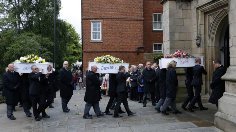 The coffins of six children who died in a house fire are carried into St Mary's Church for their funeral service in Derby, central England, Friday. Their parents, Mick and Mairead Philpott have been charged with causing their deaths.