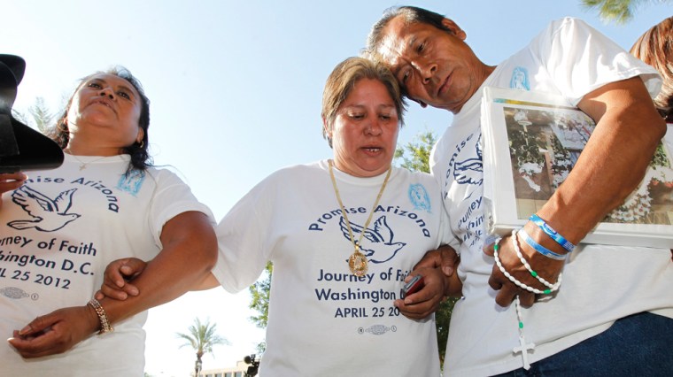 Members of Promise Arizona, from left, Leonila Martinez, Patricia Rosas and Gustavo Cruz, react to the U.S. Supreme Court decision on Arizona's controversial immigration law in Phoenix on Monday.