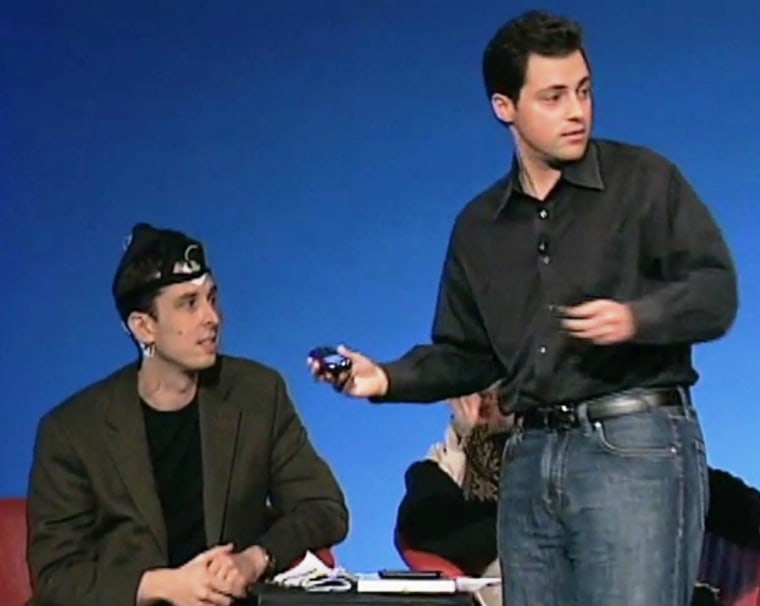 Neuroscientist Philip Low (at right) demonstrates how the iBrain device can send brain-wave readings to a cellphone with an subject who's wearing the headband (at left) during a TEDMED 2009 presentation. Click on the image to watch the YouTube clip.