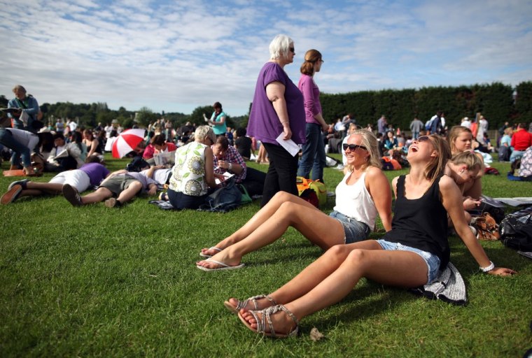 Girls relax as they wait in the queue to purchase tickets for day two of the Wimbledon Lawn Tennis Championships at the All England Lawn Tennis and Croquet Club on June 26, 2012 in London, England.