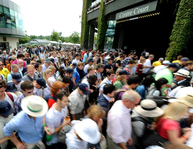 Spectators arrive at Centre Court at Wimbledon on June 26, 2012.