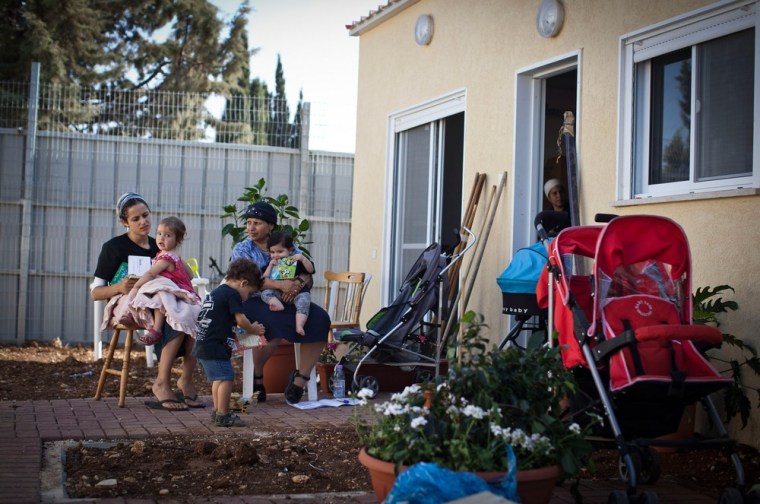 Families evicted from the Ulpana neighborhood move into temporarily housing in the nearby settlement of Beit El on June 26. This is the first day of the evacuation, during which 33 families will be moved several hundred yards to a temporary settlement located inside a military zone.