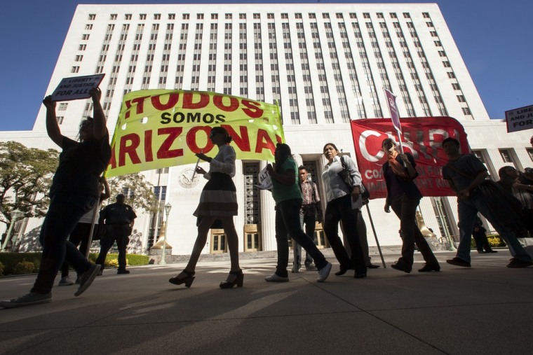 Members of the Coalition for Humane Immigrant Rights of Los Angeles hold a rally in response to the ruling by the U.S. Supreme Court on Arizona's immigration law, outside the Los Angeles Federal Court building on Monday.