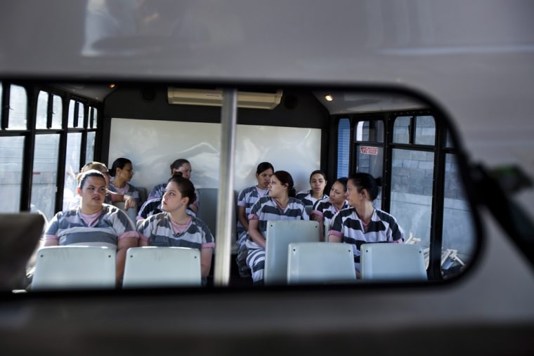 Members of the chain gang are seen in a bus driver's mirror en route to White Tanks Cemetery to help bury the indigent.