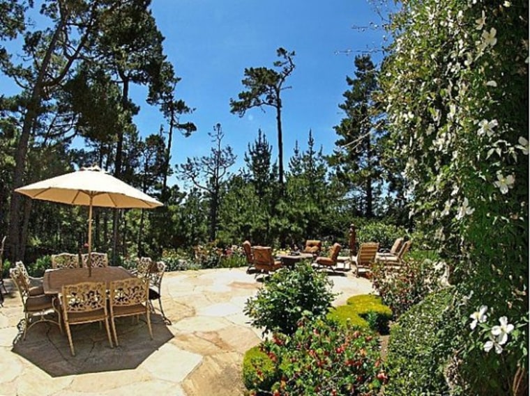 Lush greenery surrounds the home.