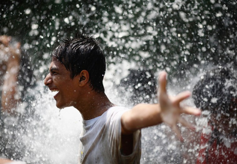A boy enjoys the waterfall as he cleans himself after celebrating Asar Pandhra festival in Pokhara valley, west of Nepal's capital Kathmandu on June 29. Farmers in Nepal celebrate the festival to mark the commencement of rice crop planting in paddy fields.