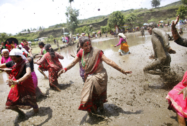 Nepalese farmers dance as they celebrate