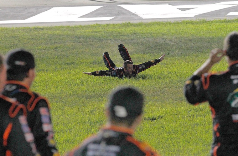 Austin Dillon performs slides in the grass after winning the race.