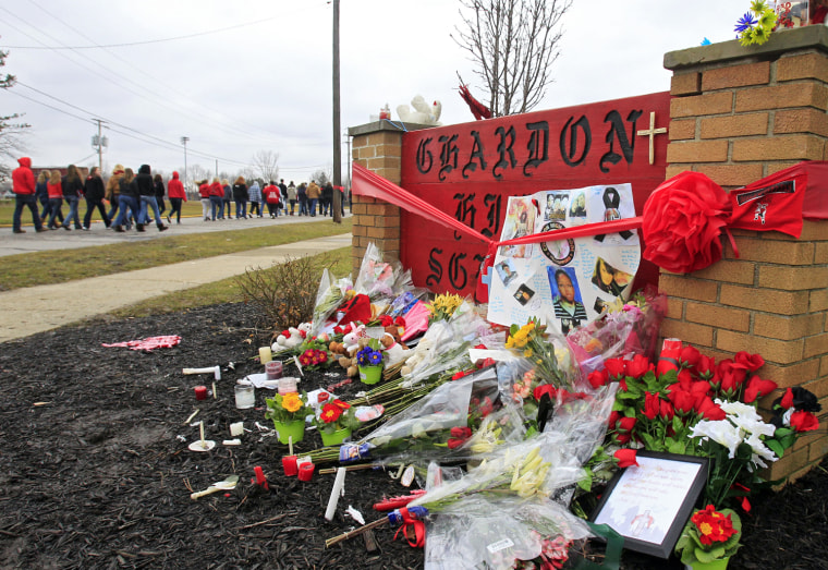 Hundreds of students and parents march to the Chardon High Schooll in Chardon, Ohio Thursday, March 1, 2012 to honor the three students who were killed in a shooting there Monday. The school re-opened to parents and students Thursday and classes resume Friday. (AP Photo/Mark Duncan)