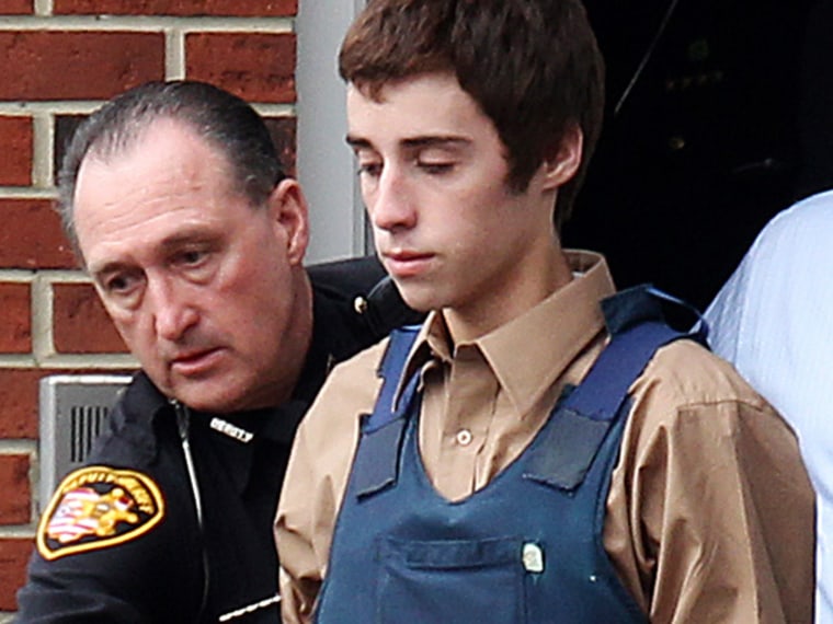 Alleged gunman TJ Lane is escorted out of the Geauga County Courthouse Annex and into a car by Sheriff deputies after his court appearance for shooting and killing three students and wounding two others at Chardon High School in Chardon, Ohio February 28, 2012. Another student has died from wounds suffered in Monday's shooting rampage at an Ohio high school, authorities said on Tuesday, as the shaken suburban Cleveland town prepared for a vigil for the teenage victims of the attack. REUTERS/Aaron Josefczyk (UNITED STATES - Tags: CRIME LAW)