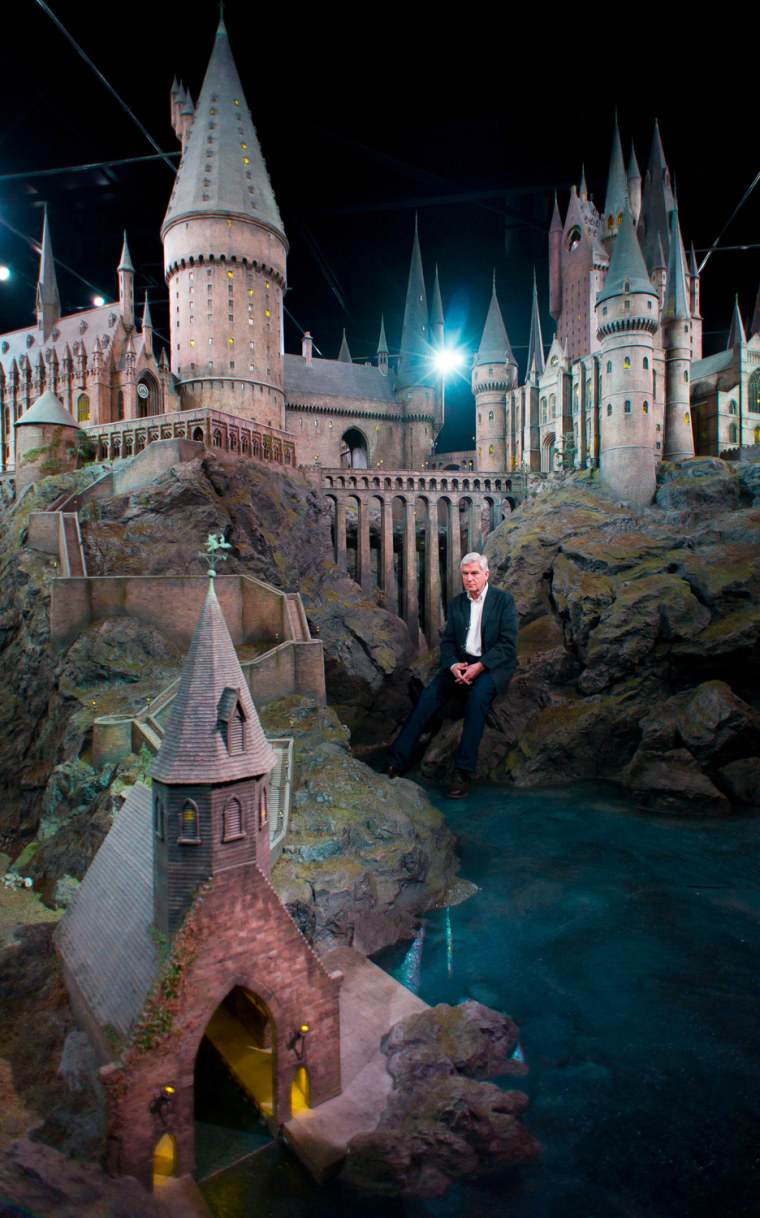 Stuart Craig, production manager, unveils a model of Hogwarts castle at the Warner Bros Studio Tour, Watford, London, Thursday, March 1, 2012. The Hogwarts castle model was built for the first film 'Harry Potter and the Philosopher's Stone', it was created for aerial photography and was digitally scanned for CGI scenes. It took 86 artists and crew members to construct, it measures over 50 feet in diameter and has over 2,500 fibre optic lights. (AP Photo/Jonathan Short)