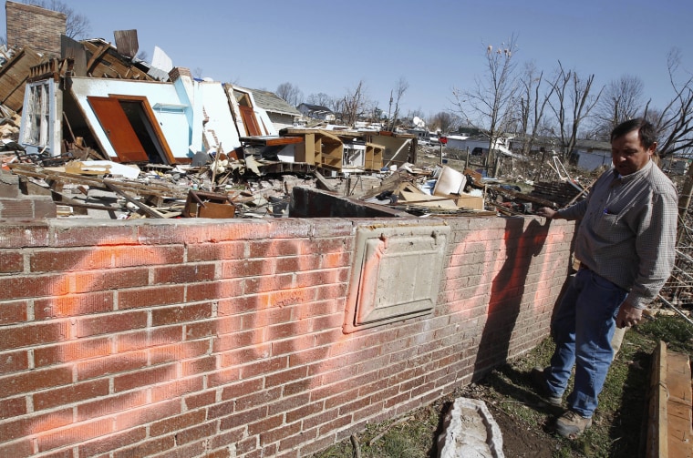 Ed Mellton looks over the remains of a rental house he owned, which was destroyed by a tornado in Harrisburg, Illinois March 1, 2012. Powerful storms that spawned tornadoes ripped through the U.S. Midwest on Wednesday, killing at least 12 people, including six in Illinois who were crushed when a house was lifted up and fell on them, authorities said. REUTERS/Jim Young (UNITED STATES - Tags: ENVIRONMENT DISASTER)