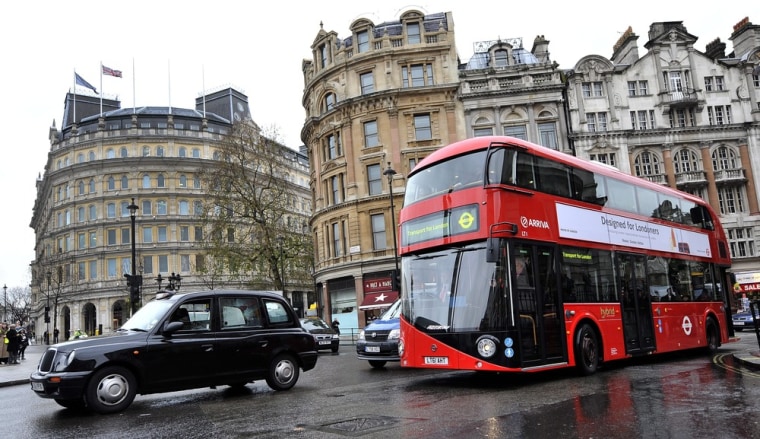 epa03035661 The new London bus drives through central London during an unveiling in London, Britain, 16 December 2011. The new London bus based on the old Routemaster style is the first bus designed specifically for London in more than 50 years. It will be the most environmentally friendly bus of its kind when it enters service in early 2012. EPA/ANDY RAIN