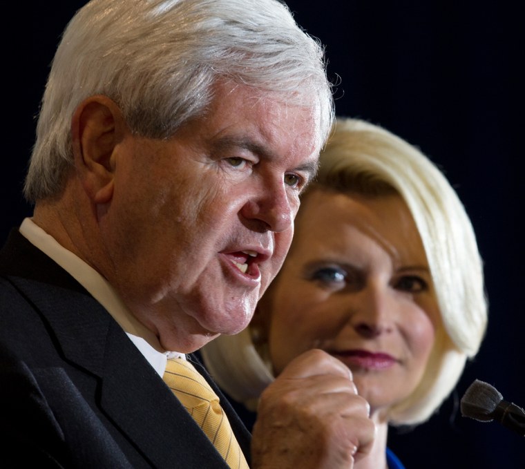 Republican presidential hopeful, former Speaker Newt Gingrich delivers remarks to supporters with his wife Calista at his side, inside a aircraft hangar at the Tampa Jet Center, January 30, 2012, in Tampa, Florida. AFP Photo/Paul J. Richards (Photo credit should read PAUL J. RICHARDS/AFP/Getty Images)