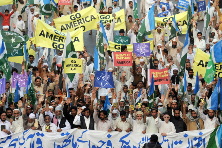 Activists of Pakistani political and Islamic party Jammat-e-Islami (JI), hold up Korans and placards during an anti-US protest over the recent burning of Korans in Afghanistan, in Karachi on March 2, 2012. Two US soldiers were killed by Afghan colleagues on March 1, the latest in a series of such attacks after the burning of Korans at a US base sparked widespread violent protests. In Afghanistan 40 people have been killed in six days of violent demonstrations as protesters targeted Western bases, plunging relations between US-led Western forces and their Afghan allies to an all time low. AFP PHOTO / RIZWAN TABASSUM (Photo credit should read RIZWAN TABASSUM/AFP/Getty Images)