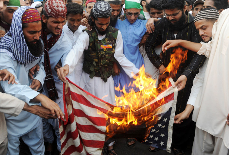 Pakistani Muslims set fire to a US flag during a protest over the recent burning of Korans in Afghanistan, in Karachi on March 2, 2012. The United Nations said March 1 the perpetrators of the Koran burning in Afghanistan should be punished, but insisted ties between the international community and the Afghan people would emerge stronger. The burning sparked widespread protests, leaving 30 people dead and over 200 wounded. AFP PHOTO / RIZWAN TABASSUM (Photo credit should read RIZWAN TABASSUM/AFP/Getty Images)