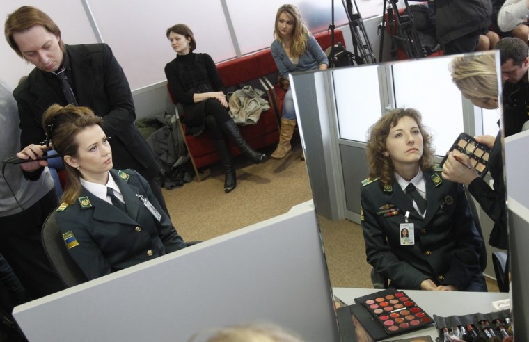 Ukrainian border guards take part in a master class in the Borispol airport near Kiev on Friday. Hairdressers and make-up artists conducted master classes for Ukrainian border guards who will meet tourists at Ukraine's main air hub during the Euro 2012 football championship.