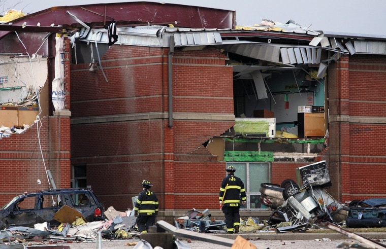 Fireman examine damage at a school in Henryville, Ind., after powerful storms stretching from the U.S. Gulf Coast to the Great Lakes in the north wrecked two small towns and killed at least eight people on March 2.