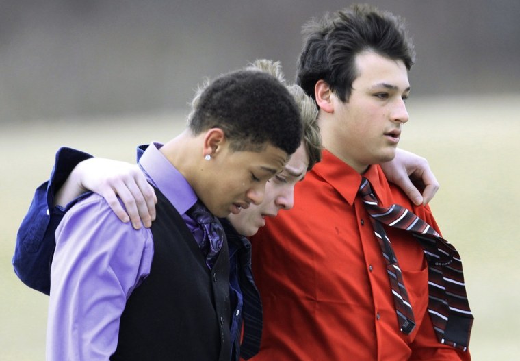Three boys walk after the burial of Daniel Parmertor at All Soul's Cemetery Saturday, March 3, 2012, in Chardon, Ohio. Parmertor and two others were fatally shot Monday at Chardon High School.(AP Photo/Tony Dejak)