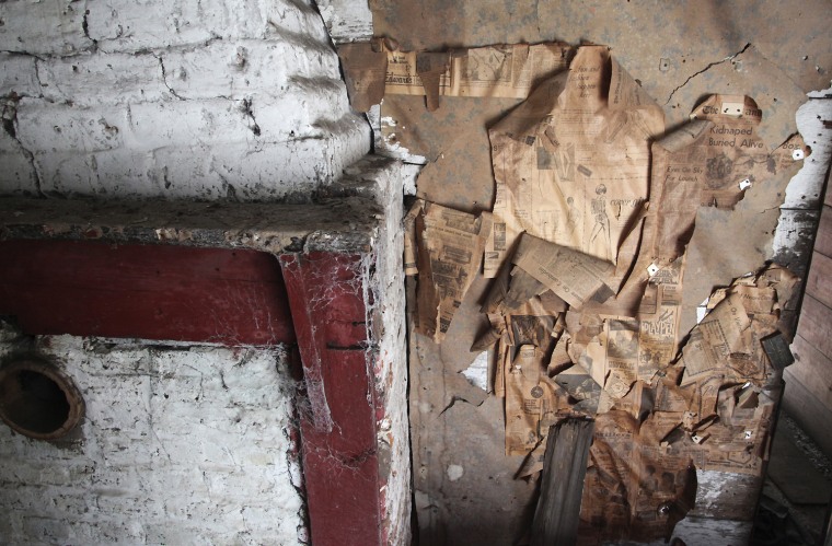 Layers of wall coverings peel from the walls of the slave quarters at Friendfield Plantation, in Georgetown, South Carolina, February 17, 2012. The buildings used up to the 1970s and were homes of the plantation workers and sharechoppers. In the South Carolina Lowcountry, more than a half-dozen antebellum plantations, which don't change hands often, are for sale. Picture taken February 17, 2012. REUTERS/Randall Hill (UNITED STATES - Tags: REAL ESTATE BUSINESS SOCIETY TRAVEL)