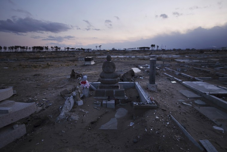 Buddhist tombstones stand in the empty land which was once a crowded residential area in Sendai, Miyagi, Japan on Feb 18, 2012. A Massive earthquake and tsunami hit northern Japan on March 11, 2011, sweeping away many coastal towns like this, killing over 15,000 and 3,000 are still missing. Photo by Kuni Takahashi