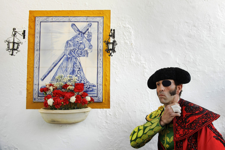 Spanish bullfighter Juan Jose Padilla adjusts his 'capote' before a bullfight in the southwestern Spanish town of Olivenza, Sunday, March 4, 2012. Padilla, who lost sight in one eye and has partial facial paralysis after a terrifying goring returned to the bullring Sunday, five months after his injury. (AP Photo/Daniel Ochoa de Olza)
