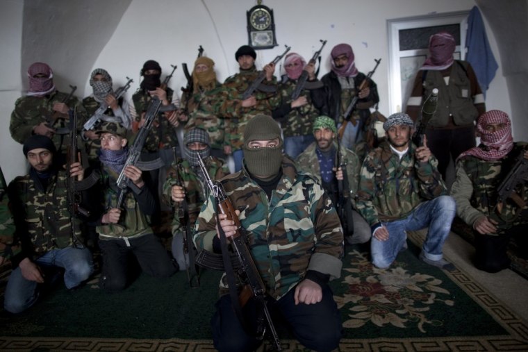 Free Syrian Army fighters pose for a portrait at their headquarters in Idlib, north Syria, Sunday, March 4, 2012. (AP Photo/Rodrigo Abd)