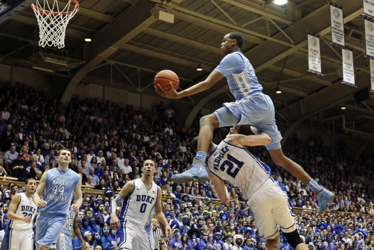 North Carolina's John Henson jumps over Duke's Miles Plumlee (21) for a shot during the first half of an NCAA college basketball game in Durham, N.C., Saturday, March 3, 2012. At rear, Duke's Seth Curry and Austin Rivers (0) watch with North Carolina's Tyler Zeller (44). (AP Photo/Gerry Broome)