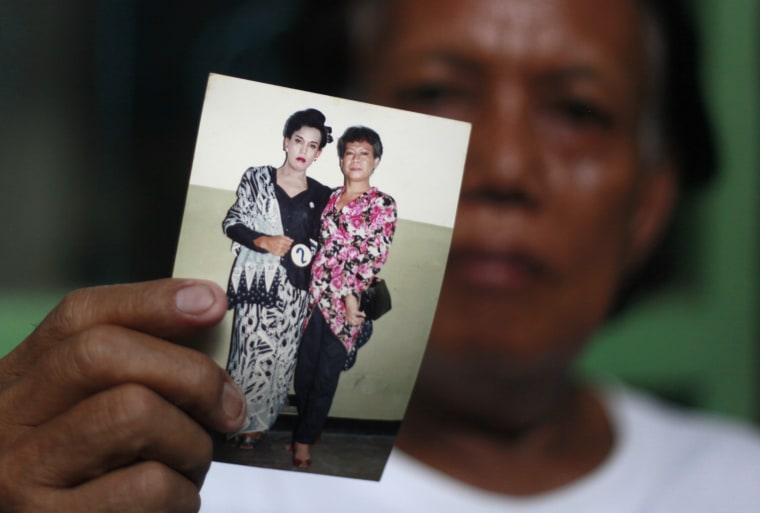 In this Friday, Jan. 27, 2012 photo, Evie, also known as Turdi, the former nanny of U.S. President Barack Obama, shows a picture of herself, left, dressed as a woman with an unidentified friend in a pageant, in Jakarta, Indonesia. Evie, who was born a man but believes she is really a woman, has endured a lifetime of taunts and beatings because of her identity. Nobody knows how many transgenders live in the sprawling archipelagic nation of 240 million, but activists estimate 7 million. However, societal disdain still runs deep - when transgenders act in TV comedies, they are invariably the brunt of the joke. (AP Photo/Dita Alangkara)