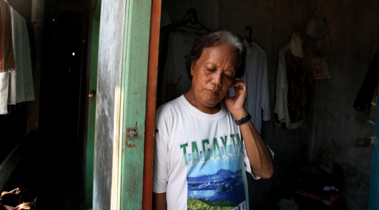 In this Friday, Jan. 27, 2012 photo, Evie, also known as Turdi, the former nanny of U.S. President Barack Obama, stands at the doorway of her room at a boarding house in a slum in Jakarta, Indonesia. Evie, who was born a man but believes she is really a woman, has endured a lifetime of taunts and beatings because of her identity. Nobody knows how many transgenders live in the sprawling archipelagic nation of 240 million, but activists estimate 7 million. However, societal disdain still runs deep - when transgenders act in TV comedies, they are invariably the brunt of the joke. (AP Photo/Dita Alangkara)