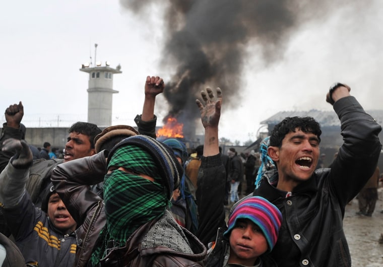 Afghan demonstrators shout anti-US slogans at the gate of Bagram airbase during a protest against Koran desecration on February 21, 2012 at Bagram about 60 kilometres (40 miles) north of Kabul. Afghan protestors firing slingshots and petrol bombs besieged one of the largest US-run military bases in Afghanistan, furious over reports that NATO had set fire to copies of the Koran. Guards at Bagram airbase responded by firing rubber bullets from a watchtower, an AFP photographer said as the crowd shouted