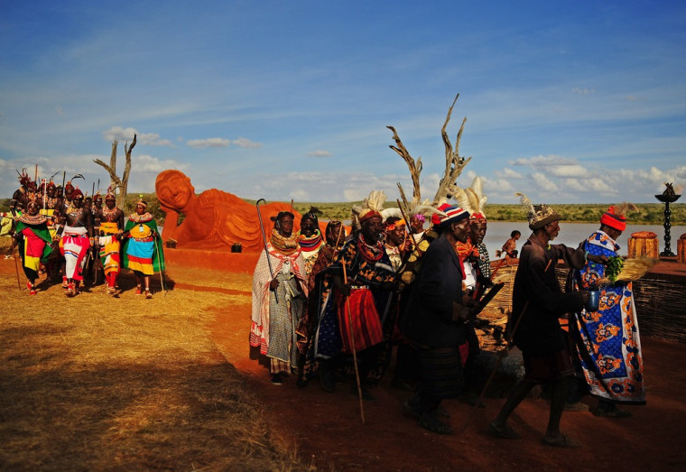 Kenyan tribal elders (R) and Samburu tribemen (L) dance in front of a statue of Buddha at the Gallmann nature conservancy near Kinamba, Laikipia, northern Kenya on Sunday. High Priest Shinso Ito and a group of Shinnyo-en priests arrived in Kenya to perform a Buddhist fire and water ceremony for the first time ever in Africa. The ceremony was attended by over 300 spiritual leaders and was streamed live on the internet to millions of viewers and devotees globally. The ceremony involved Kenyan tribal elders and members of the Njemps, Pokot Samburu, Kikuyu and Turkana communites.