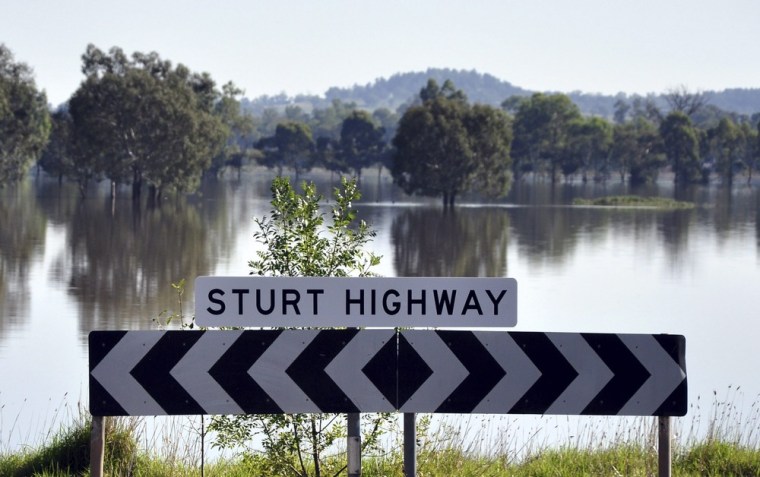 epa03133379 A handout image released by the Wagga Wagga City Council shows the flood waters over the Sturt Highway in Flowerdale near Wagga Wagga, Australia, 06 March 2012. A mass evacuation of the city and its suburbs was ordered on 05 March night, with an estimated 8,000 people forced from their homes ahead of the Murrimbidgee River's predicted peak around midday. EPA/DANNIELLE UPFIELD EDITORIAL USE ONLY AUSTRALIA AND NEW ZEALAND OUT HANDOUT EDITORIAL USE ONLY
