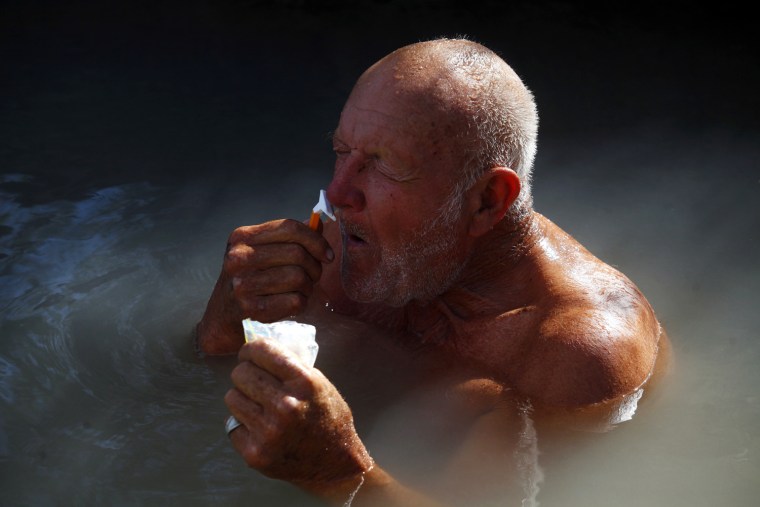 ATTENTION EDITORS: PICTURE 16 OF 30 FOR PACKAGE 'LIFE IN SLAB CITY' A man shaves in a hot spring in Slab City just outside Niland, California February 16, 2012. A former military base that was closed after World War II, Slab City is a place on the fringe both geographically and philosophically and attracts a variety of people, including jobless and financially struggling recession refugees who can no longer pay for food and housing. Picture taken February 16, 2012. REUTERS/Eric Thayer (UNITED STATES - Tags: SOCIETY)