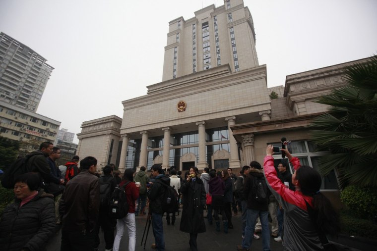 REFILE - CORRECTING NAME OF COURT Reporters wait outside the Higher People's Court of Guangdong in Guangzhou, Guangdong province February 29, 2012. Lawyers for Apple Inc. argued for its right to use the iPad trademark in China on Wednesday, as a higher court began a crucial hearing that could result in sales of the wildly popular tablet computer being halted throughout the Chinese mainland. The Higher People's Court of Guangdong is hearing an appeal by the U.S. firm after a lower court ruled in favour of debt-laden Chinese tech company Proview Technology (Shenzhen), which says it owns the trademark in China. REUTERS/Alvin Chan (CHINA - Tags: BUSINESS SCIENCE TECHNOLOGY CRIME LAW) CHINA OUT. NO COMMERCIAL OR EDITORIAL SALES IN CHINA