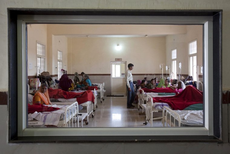 Women who have recently given birth and their relatives are pictured through a nurse's observaton window as they rest in a post delivery ward at a district hospital in Shivpuri, in the central Indian state of Madhya Pradesh, February 25, 2012. In rural Madhya Pradesh, an innovative free maternity ambulance service called