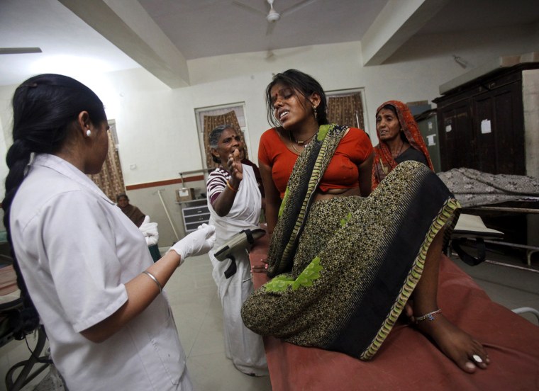 Pravesh Chandravansingh Yadav, a 25-year-old woman in labour, winces in pain as she tries to lie down on a maternity table at a district hospital in Shivpuri, in the central Indian state of Madhya Pradesh, February 25, 2012. In rural Madhya Pradesh, an innovative free maternity ambulance service called