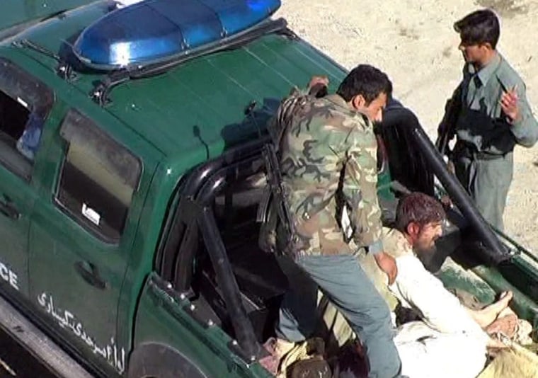 epa03135174 Afghan policeman tranfers an injured victim to a local hospital in Spin Boldak town of Afghanistan, along the Pak-Afghan border, Afghanistan 07 March 2012. A motorcycle bomb in southern Afghanistan near Pakistan’s border killed four civilians and injured eight, a government official said on 07 March. The bomb exploded in a crowded area in Spin Boldak district of Kandahar province on Wednesday morning, Parwiz Najib, a senior official in the provincial governor’s office said. EPA/AKHTER GULFAM