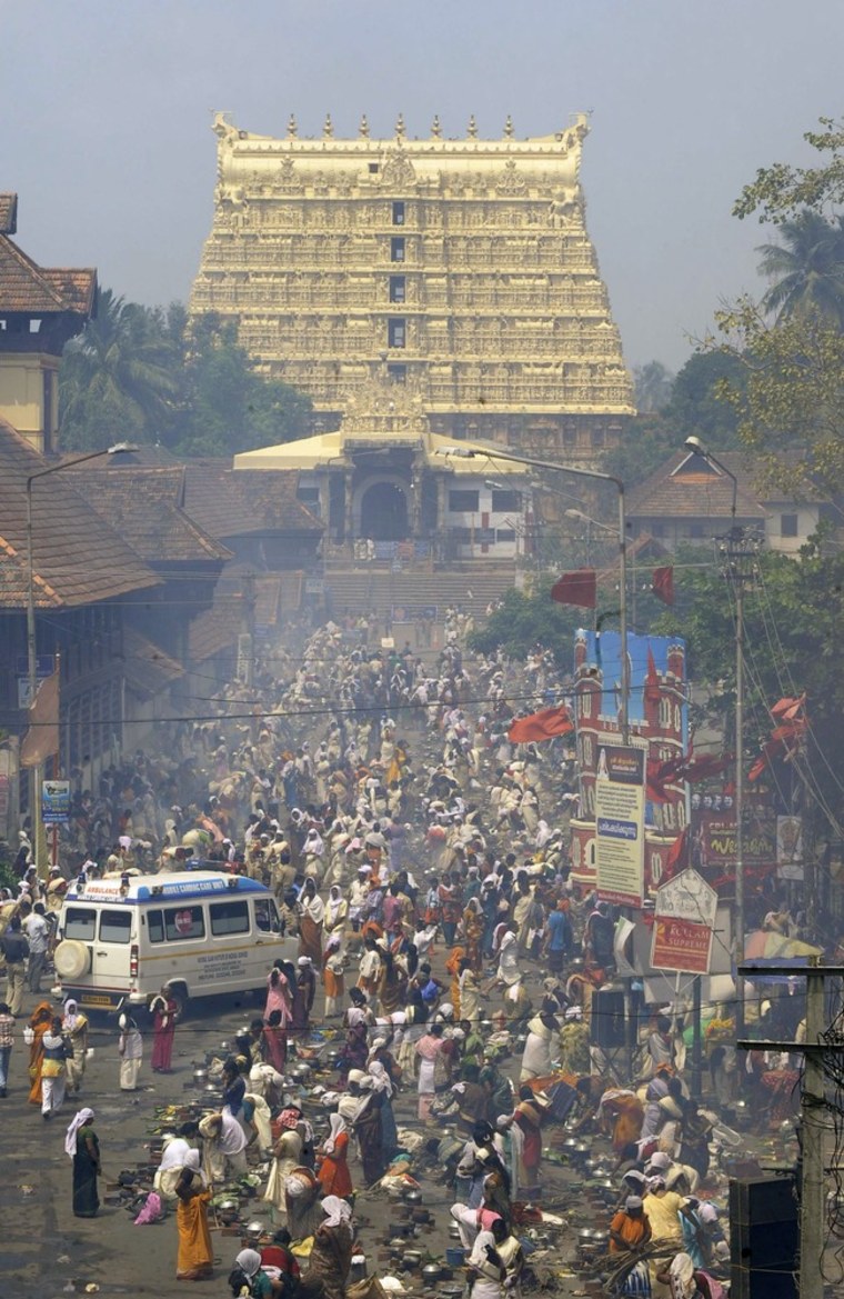 Hindu devotees pray and prepare rice porridge in the streets surrounding the Attukal Bhagavathy Temple in Thiruvananthapuram on Tuesday as they take part in the Pongala Festival or Attukal Pongala in the southern state of Kerala. More than 3.5 million women took part in the festival which is attempting entry into the Guiness Book of World Records for the largest gathering of women at a festival in the world.