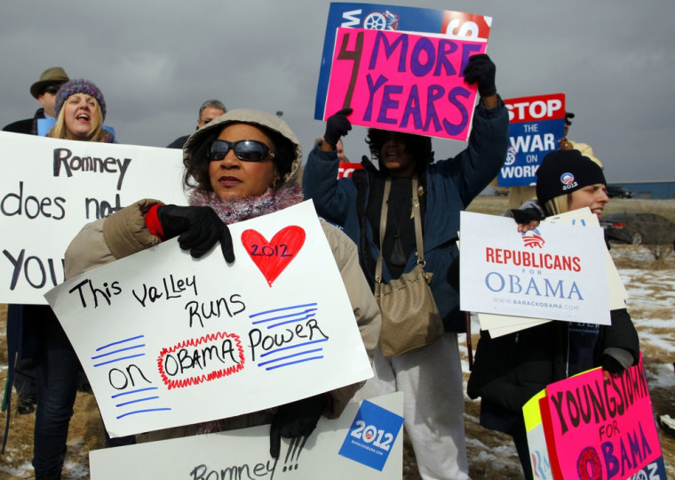 Supporters of U.S. President Barack Obama stand outside a campaign stop by Republican presidential candidate and former Massachusetts Governor Mitt Romney in Youngstown, Ohio March 5, 2012. REUTERS/Brian Snyder (UNITED STATES - Tags: POLITICS ELECTIONS)