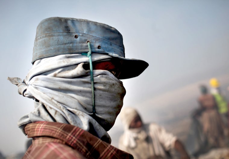 PORT-AU-PRINCE, HAITI - MARCH 07: Children and adults scavenge for recyclables and other usable items at the Trutier dump on the outskirts of Port-au-Prince, on March 7, 2012 in Port-au-Prince, Haiti. Following the devastating earthquake two years ago that killed and estimated 316,000 people, the number of scavengers at the landfill has grown from about 200 to an estimated 2,000. Much of Haiti is still in a crisis situation with tens of thousands living in tent camps in and around Port-au-Prince. A growing concern to international donors is a flare-up between ex-members of Haiti's armed forces and the current Haitian President Michel Martelly. (Photo by Spencer Platt/Getty Images)
