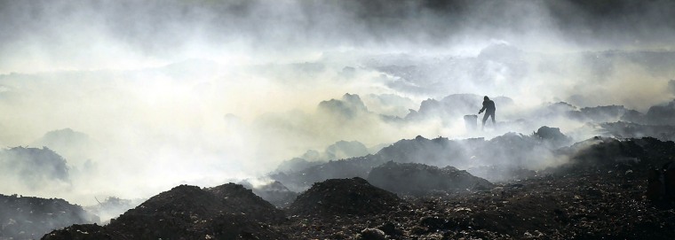 PORT-AU-PRINCE, HAITI - MARCH 07: A lone man scavenges for recyclable and other usable items at the Trutier dump on the outskirts of Port-au-Prince, on March 7, 2012 in Port-au-Prince, Haiti. Following the devastating earthquake two years ago that killed and estimated 316,000 people, the number of scavengers at the landfill has grown from about 200 to an estimated 2,000. Much of Haiti is still in a crisis situation with tens of thousands living in tent camps in and around Port-au-Prince. A growing concern to international donors is a flare-up between ex-members of Haiti's armed forces and the current Haitian President Michel Martelly. (Photo by Spencer Platt/Getty Images)