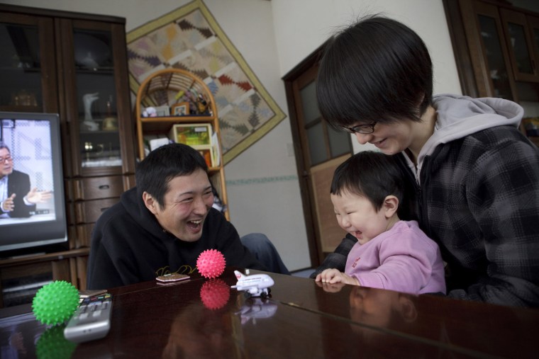 Koya Takahashi, left, and his wife, Megumi, play with their son, Nagato, 11month, at their house in Minamisanriku, Miyagi, Japan on Feb 26, 2012. Nagato was born six days after the massive earthquake and tsunami hit northern Japan on March 11, 2011, sweeping away many coastal towns including Minamisanriku. Photo by Kuni Takahashi