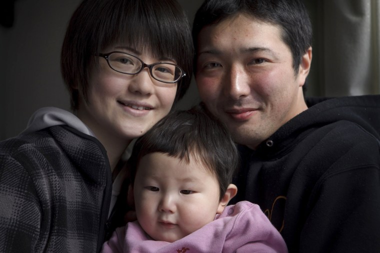 Megumi Takahashi, left, and her husband, Koya, poses with their son, Nagato, 11month, at their house in Minamisanriku, Miyagi, Japan on Feb 26, 2012. Nagato was born six days after the massive earthquake and tsunami hit northern Japan on March 11, 2011, sweeping away many coastal towns including Minamisanriku. Photo by Kuni Takahashi